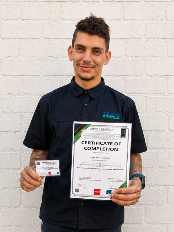 Chris holding his First Aid Level 1 certificate